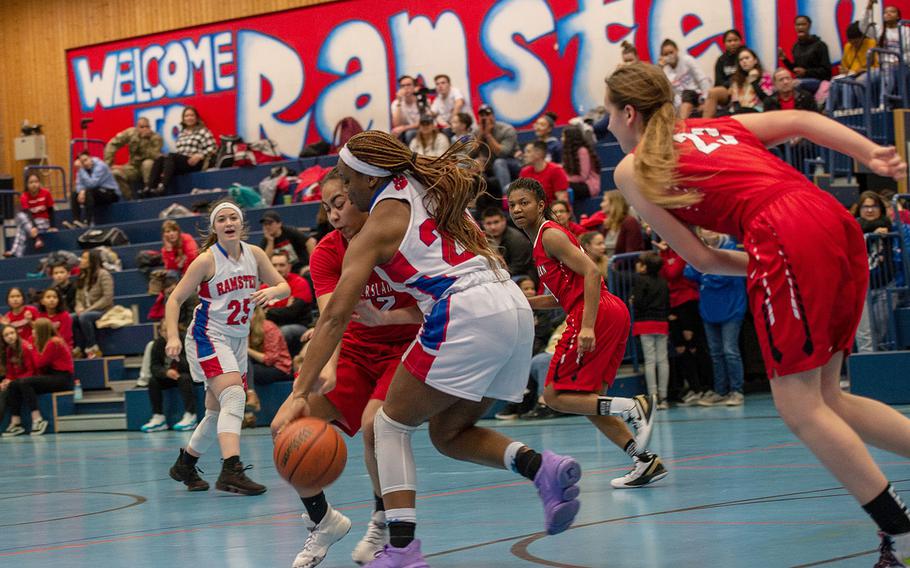 Kaiserslautern's Maya Henderson fouls Ramstein's Shannon McCray during the final seconds of a basketball game at Ramstein High School, Germany, Friday, Feb. 7, 2020. Ramstein won the game 34-30.  