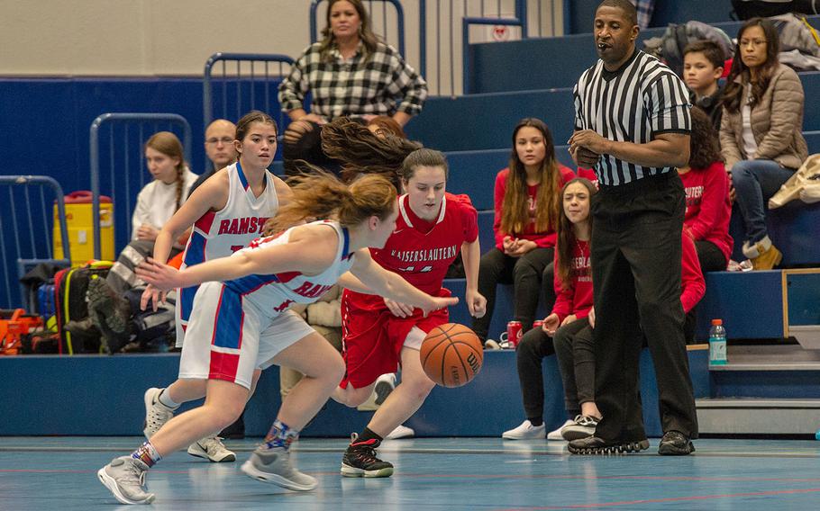 Players go for a loose ball during a basketball game between Kaiserslautern and Ramstein at Ramstein High School, Germany, Friday, Feb. 7, 2020. Ramstein won the game 34-30.  