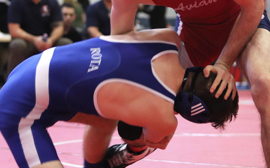 Michael Hauser of the Aviano Saints defends against Rota Admirals' Jordan Cookerly in the 145-pound weight class matchup of Saturday's wrestling sectional held at Aviano, Italy. Hauser won the match by pin and finished the day in first place.