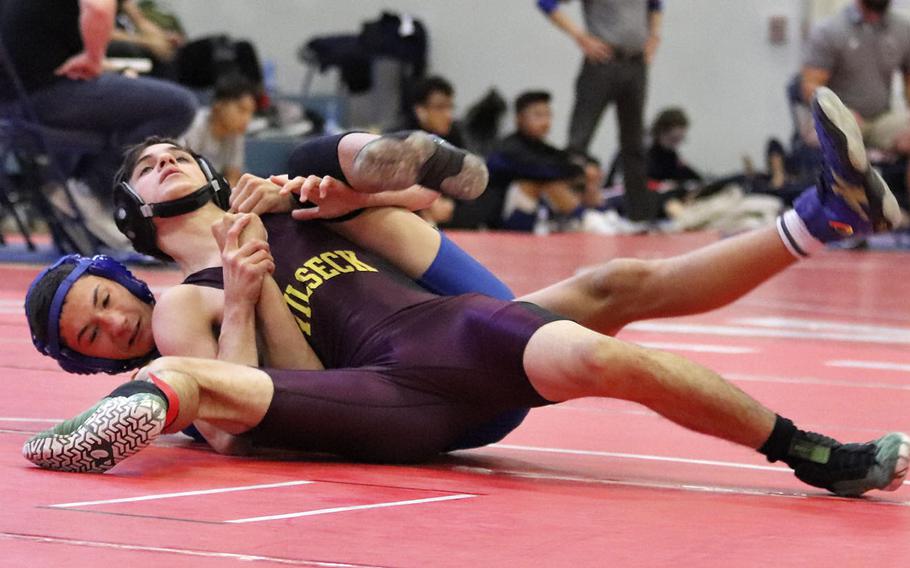 Vilseck's Johnathan Alvarado attempts a rollover on Sigonella's Dylan Estes in the 120-pound, third place matchup of Saturday's wrestling sectional held at Aviano, Italy. Alvarado pinned Estes for the win and the third-place finish.