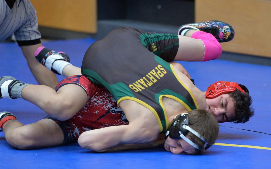 In a 113-pound match SHAPE’s Asa Keltner, top, tries to put the pressure on Lakenheath’s Tyler Villarreal on the first day of action at the DODEA-Europe wrestling championships in Wiesbaden, Germany, Saturday, Feb. 14, 2020. Villarreal turned the tables and won the match.