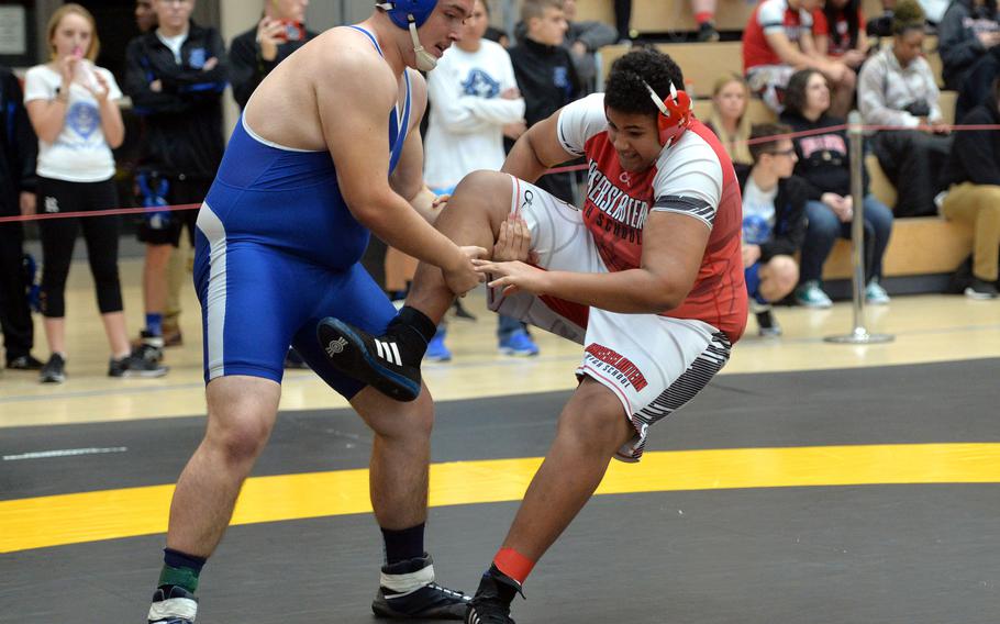 Rota's Charles Everhart pulls down Kaiserslautern's Anthony Zamor in a 285-pound match match at the DODEA-Europe wrestling championships in Wiesbaden, Germany, Friday, Feb. 14, 2020. Everhart went on to win the match.