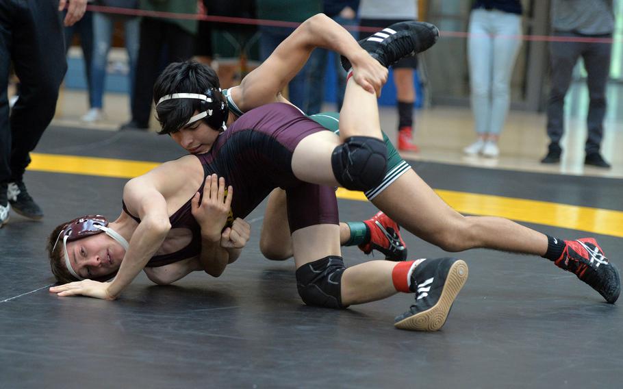 Naples' Giancarlo Forero has Vilseck's Samuel Villasenor in his grip in a 132-pound match on the first day of action at the DODEA-Europe wrestling championships in Wiesbaden, Germany, Friday, Feb. 14, 2020. Forero went on to win.
