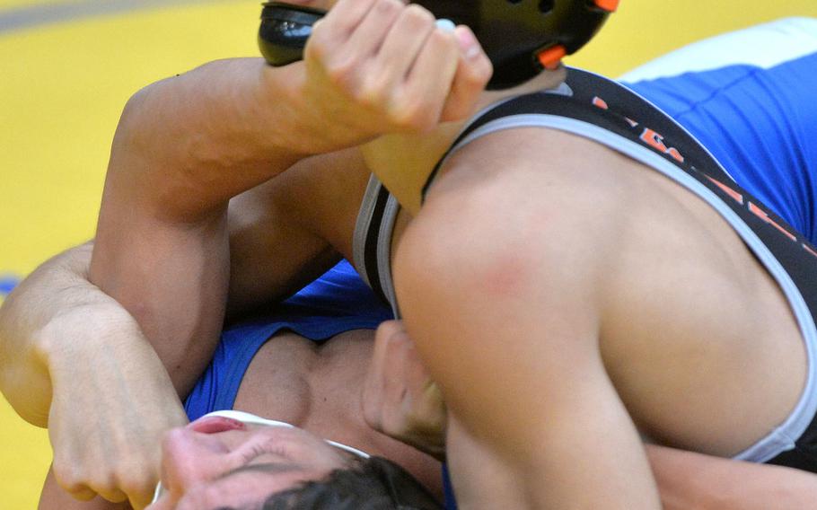 Spangdahlem's Carson Hicks puts the pressure on Seth Robles of Hohenfels in a 120-pound match on the first day of action at the DODEA-Europe wrestling championships in Wiesbaden, Germany, Friday, Feb. 14, 2020. Hicks went on to beat Robles.