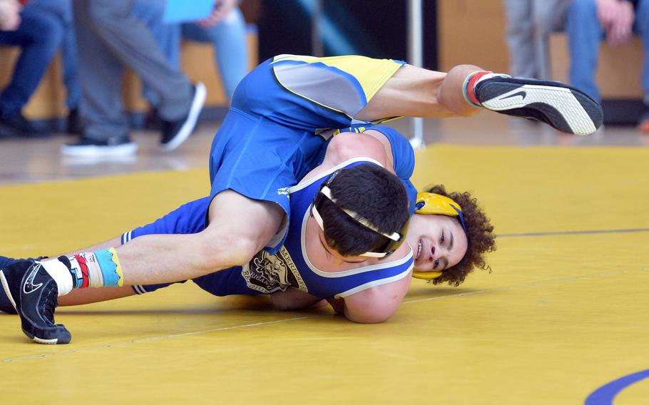 Wiesbaden's Reyder Rivera Sanchez, top, tries to turn Brussels' Adrian Caban on his way to winning a 113-pound match on the first day of action at the DODEA-Europe wrestling championships in Wiesbaden, Germany, Friday, Feb. 14, 2020.