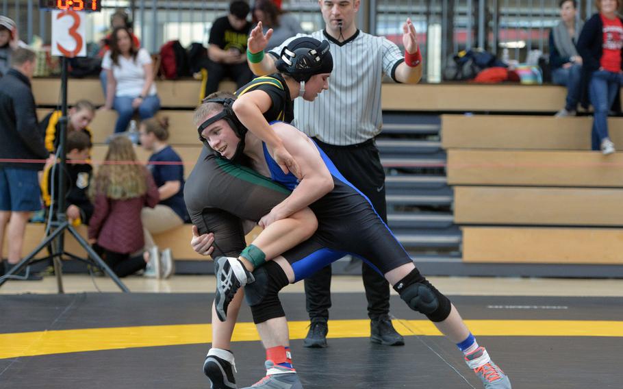 Brussels' Ethan Bell prepares to take down SHAPE's Nicolene Anduaga-Arias in a 106-pound match on the first day of action at the DODEA-Europe wrestling championships in Wiesbaden, Germany, Friday, Feb. 14, 2020.