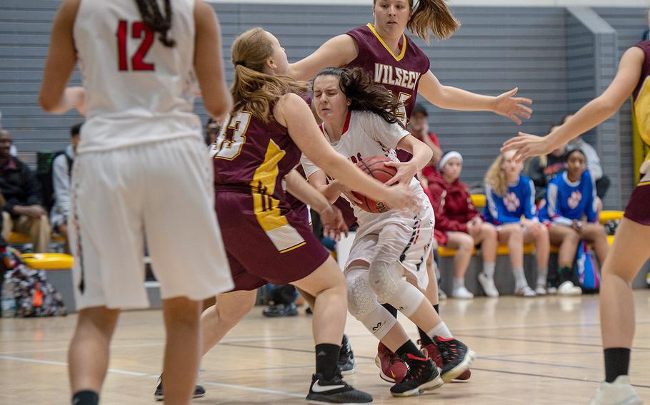 Kaiserslautern's Rebecca Moon is fouled by players from Vilseck during the DODEA-Europe 2020 Division I basketball playoffs at the Southside gym on Ramstein Air Base, Germany, Thursday, Feb. 20, 2020. 