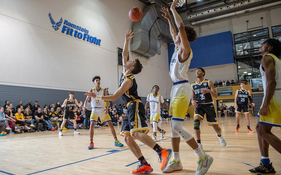 Stuttgart's Tyler Farrar takes an over the shoulder shot after driving the baseline during a game against Wiesbaden during the DODEA-Europe 2020 Division I basketball playoffs at the Southside gym on Ramstein Air Base, Germany, Thursday, Feb. 20, 2020.