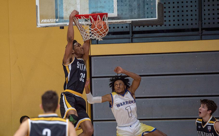 Stuttgart's Sabriel Ashley dunks during a game against Wiesbaden during the DODEA-Europe 2020 Division I basketball playoffs at the Southside gym on Ramstein Air Base, Germany, Thursday, Feb. 20, 2020. 