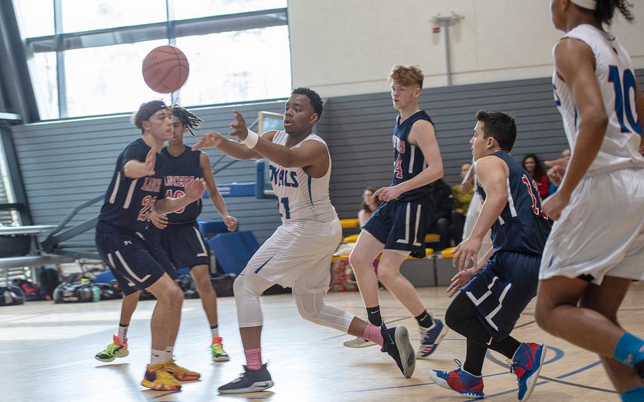 Ramstein's Carl Norman make a quick pass during a fast break during a game against Lakenheath during the DODEA-Europe 2020 Division I basketball playoffs at the Southside gym on Ramstein Air Base, Germany, Wednesday, Feb. 20, 2020. 