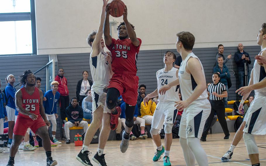 Kaiserslautern's Tre Dotson drives to the basket and makes the winning shot to beat Black Forest Academy 61-60 during the DODEA-Europe 2020 Division I basketball playoffs at the Southside gym on Ramstein Air Base, Germany, Thursday, Feb. 20, 2020. 