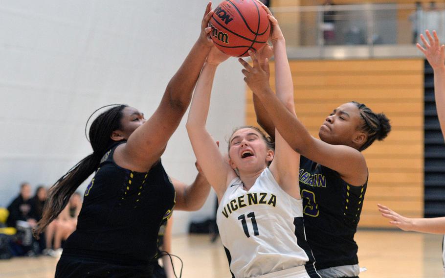 Vicenza's Kate Hunter fights for a rebound against Bahrain's Jayla Dewalt, left, and Kinnedy Sawyer in a Division II game at the DODEA-Europe basketball championships in Wiesbaden, Germany, Thursday, Feb. 20, 2020. Vicenza won the game 38-25.