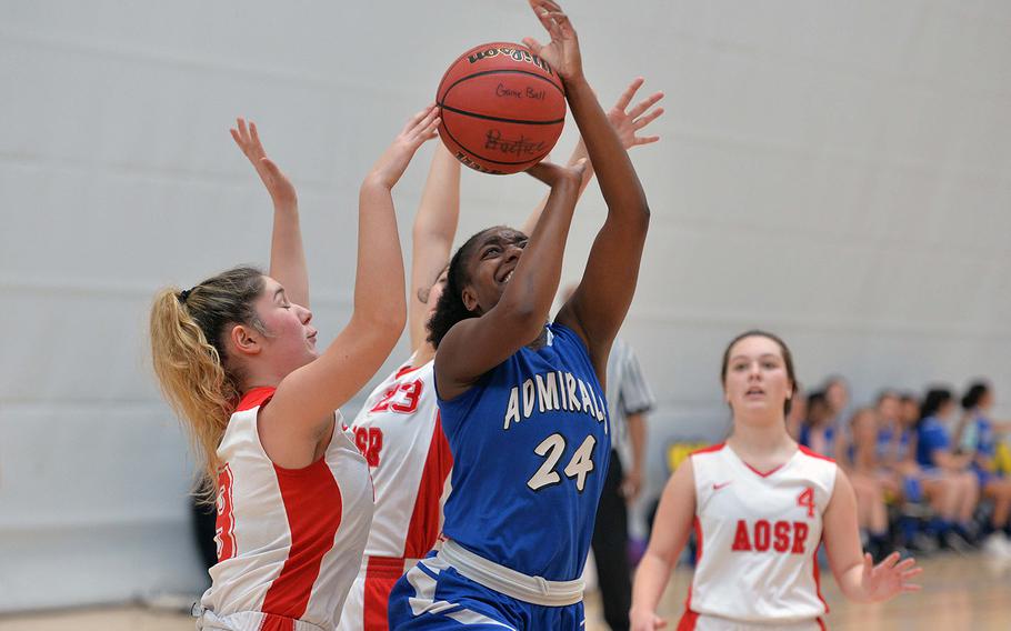 Rota's Brianna Leiba is fouled as she attempts a shot against AOSR's Claudia Ricci, left, and Maria Rossi in a Division II game at the DODEA-Europe basketball championships in Wiesbaden, Germany, Thursday, Feb. 20, 2020. AOSR won 28-11. Isabella Walsh watches the action at right.