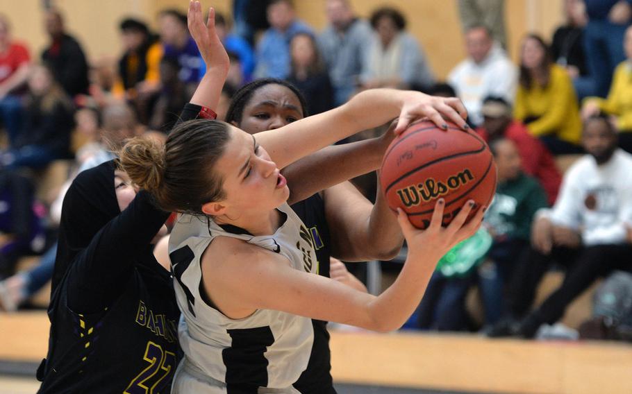 Claire Troiano of Vicenza fights for the ball with Bahrain's Taz Abdkhair and Jayla Dewalt in a Division II game at the DODEA-Europe basketball championships in Wiesbaden, Germany, Thursday, Feb. 20, 2020. Vicenza won the game 38-25.