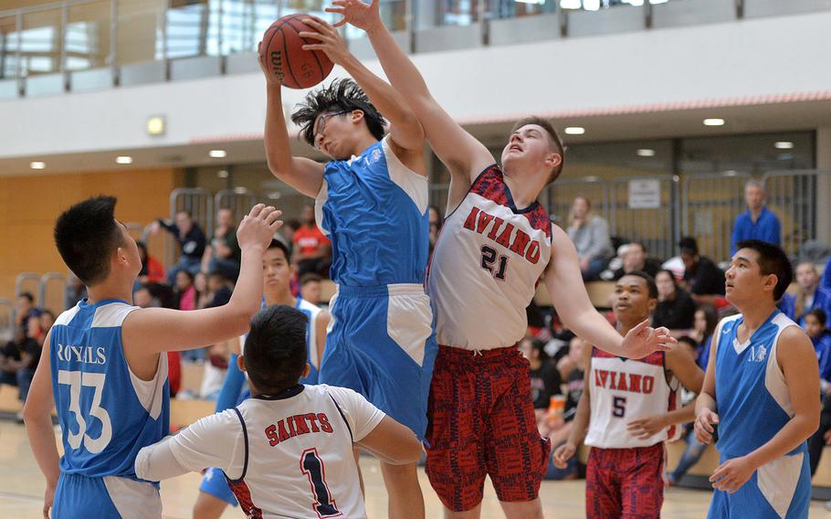 Marymount's Kevin Li pulls down a rebound against Aviano's Braden Lehde in a Division II game at the DODEA-Europe basketball championships in Wiesbaden, Germany, Thursday, Feb. 20, 2020. Aviano beat MMI 41-17.