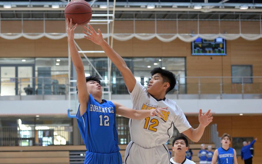 Robin Kim of Hohenfels shoots over Baumholder's Isaiah Daep in a Division III semifinal at the DODEA-Europe basketball championships in Wiesbaden, Germany, Friday, Feb. 21, 2020. Baumholder beat Hohenfels 73-58 to advance to the finals.