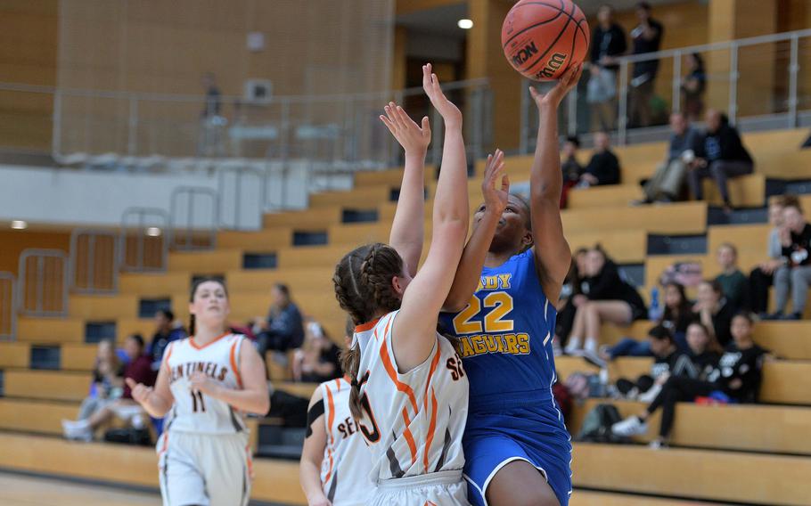 Sigonella's Shanyah Kentish shoots against Spangdahlem's Emerson Retka in a Division III semifinal at the DODEA-Europe basketball championships in Wiesbaden, Germany, Friday, Feb. 21, 2020. Spangdahlem won 39-14 to advance to the finals.