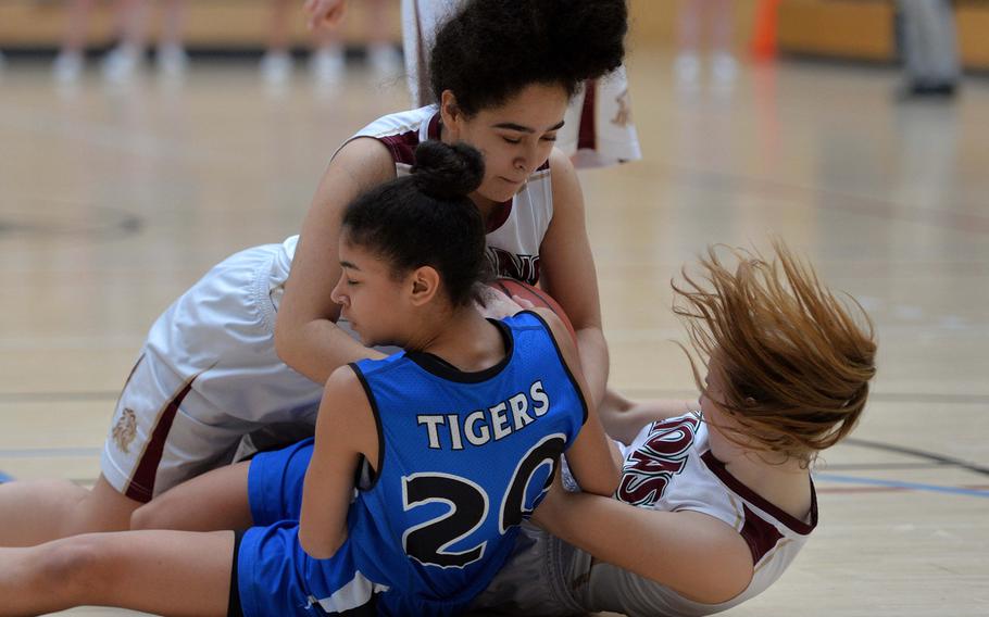 Jania Vicente of Hohenfels fights Lachelle Ellis and Katelyn Eidson of AFNORTH for the ball in a Division III semifinal at the DODEA-Europe basketball championships in Wiesbaden, Germany, Friday, Feb. 21, 2020. Hohenfels won 36-31 to advance to the finals.