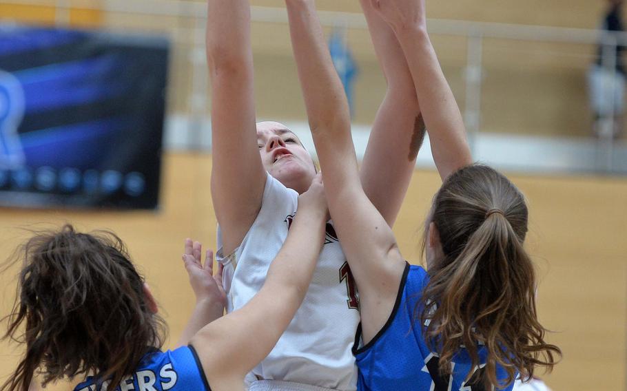 Trinity Ato of AFNORTH gets off a jumper over Rebecca Dick, left, and Allison Wenger in a Division III semifinal at the DODEA-Europe basketball championships in Wiesbaden, Germany, Friday, Feb. 21, 2020. Hohenfels won 36-31 to advance to the finals.