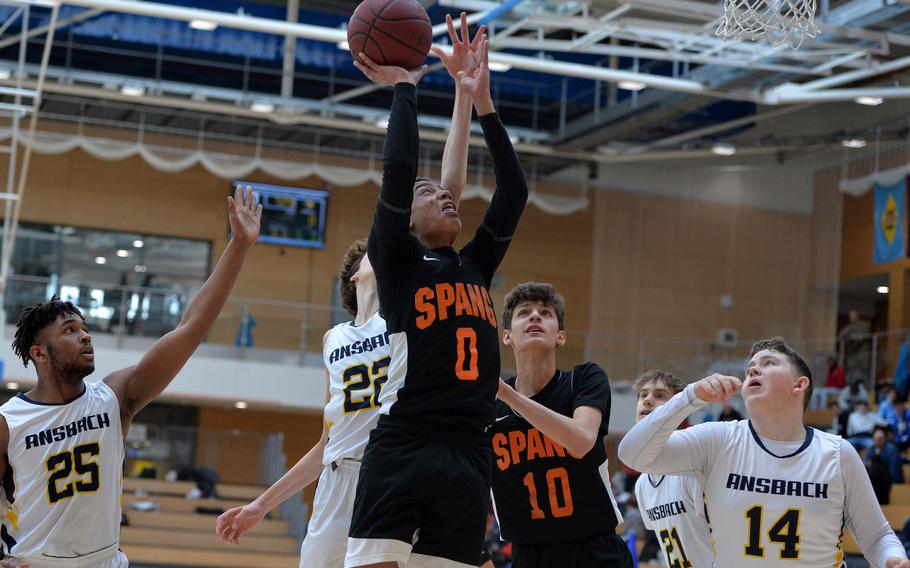 Elijah Simpson of Spangdahlem goes to the basket as Alexander Adams of Ansbach tries to get a hand on the ball in a Division II semifinal at the DODEA-Europe basketball championships in Wiesbaden, Germany, Friday, Feb. 21, 2020. 