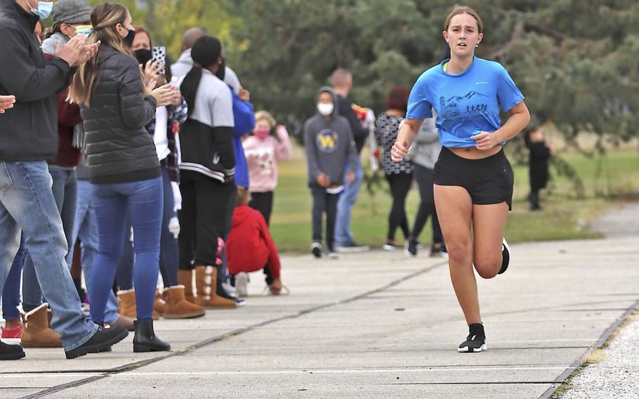 Sirin Whitcomb sprints to the finish line during Saturday's cross country meet at Aviano. A total of 15 runners competed in the event where Whitcomb finished with a time of 34 minutes, 38 seconds.