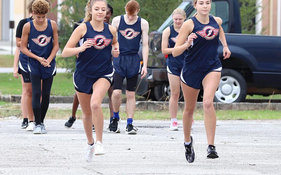 Halie Carroll, left, and Layla Hall begin their run during Saturday's cross country meet at Aviano.