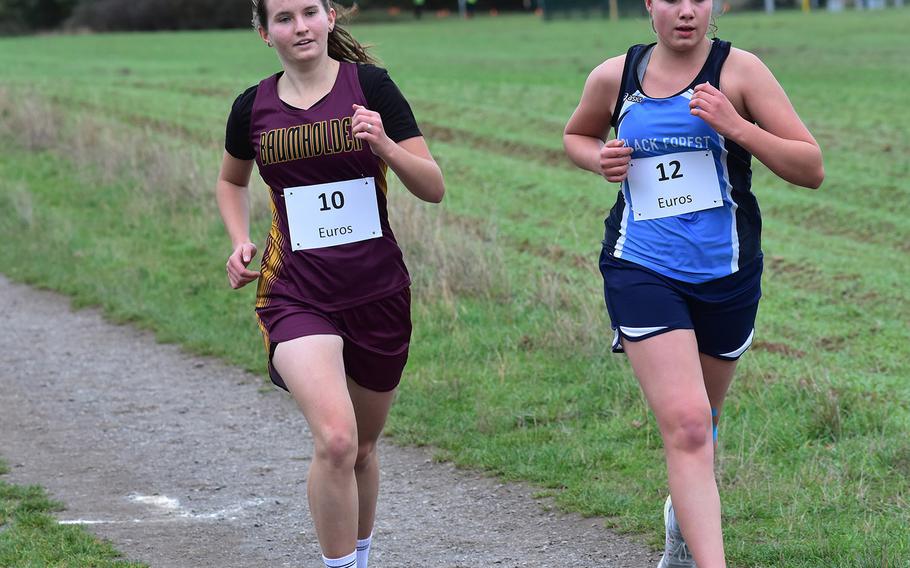 Black Forest Academy's Elmi-gret Van der Westhuizen runs alongside Baumholder's Madison Brech at the DODEA-Europe non-virtual championship on Saturday, Oct. 24, 2020, in Ramstein-Miesenbach, Germany. Van der Westhuizen won the small schools' division race and placed 12th overall.
