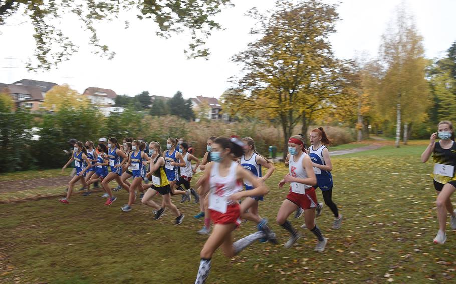 Runners in the girls large school race sprint from the starting line at the DODEA-Europe non-virtual cross country championship on Saturday, Oct. 24, 2020, at Seewoog Park in Ramstein-Miesenbach, Germany. Two girls races were held to keep runners spread out due to coronavirus, with times from both races combined into the overall results.