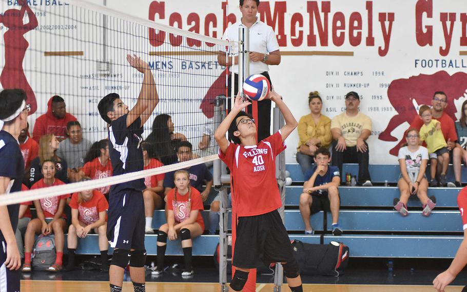 American Overseas School of Rome's Eduardo Lin sets the ball to his teammates Saturday while Aviano's Adrian Vasquez waits on the other side of the net in the Falons' 25-21, 25-20, 25-21 victory over the Saints on Saturday, Sept. 14, 2019.