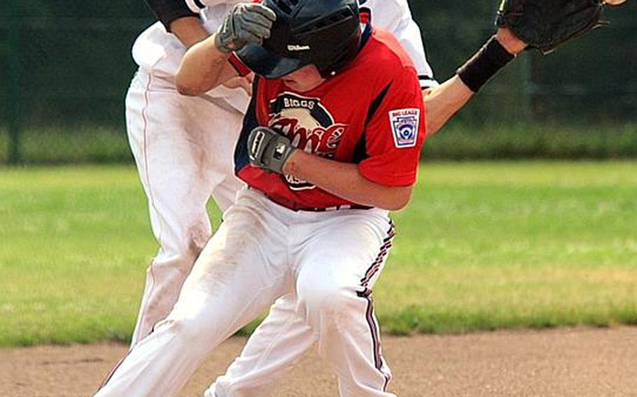 KMC's Shane Foley ducks to get out of the way of the throw to Netherlands third baseman Jesse Aussems while stealing third in a game at Ramstein, Germany, on Tuesday. The Netherlands beat KMC 12-1 to qualify for Thursday's championship game. The KMC team, made up of Americans from Germany, will play Moldova on Wednesday for a chance to a rematch with the Dutch. The champion goes to the Big League World Series in Easley, S.C.
Michael Abrams/Stars and Stripes