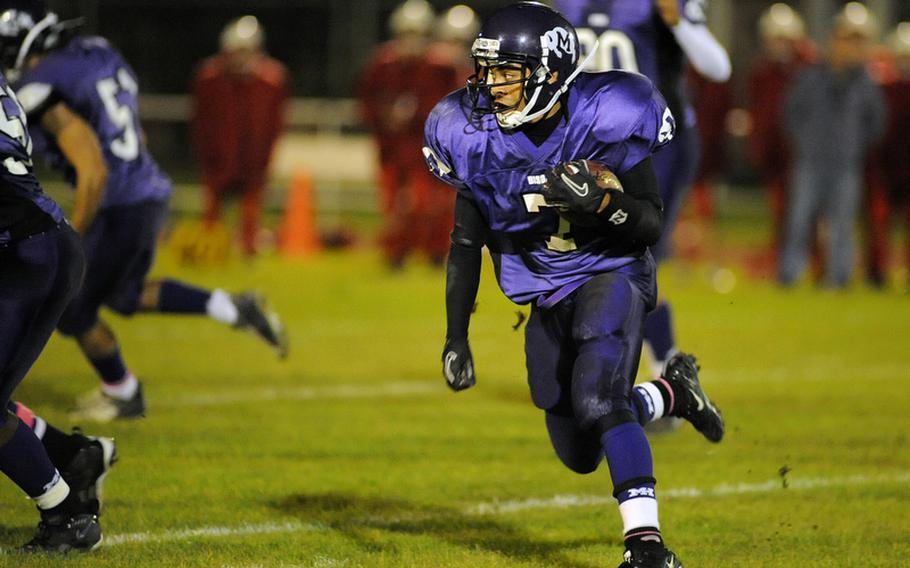 Mannheim's Calvin Baisden looks for daylight as he rushes for a gain against ISB on Friday night. Mannheim won their final regular season home game 21-14.