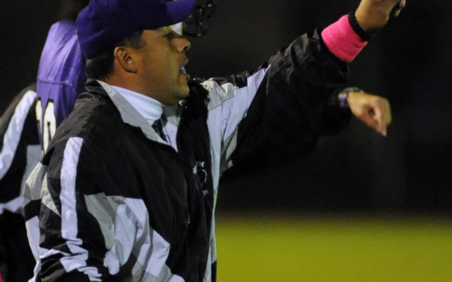 Mannheim head coach Frank Macias signals in a play to his Bison team. Mannheim won their final regular season home game, defeating ISB 21-14, on Friday night.