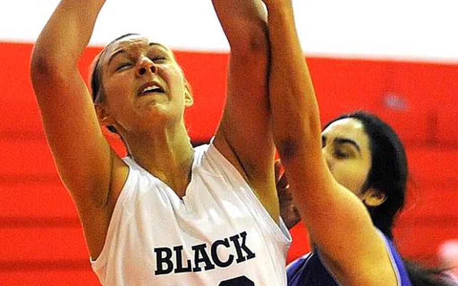 Black Forest Academy's Esther Shady is fouled by Bahrain's Fatema Alshakar in a Division II game at the DODDS Europe basketball championships on Wednesday. BFA beat Bahrain, 44-17.