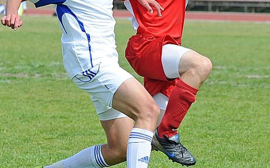 Ramstein's Drew Guffey, left, and Kaiserslautern's Erik Langholz battle for the ball in a game at Ramstein on Saturday. Ramstein won 4-0 in both Division I teams' final game before the DODDS-Europe championships.