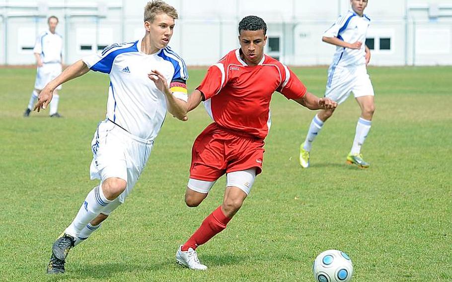 Ramstein's Jonathon McLouth, left, tries to get by Kaiserslautern defender Dominique Williams in Ramstein's 4-0 win over the Raiders on Saturday.