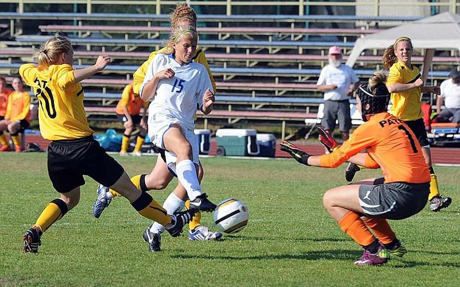 Tori Coleman scores Ramstein's only goal in a 2-1 loss against Patch as she sends the ball past Patch keeper Johanna Quinn. Patch's Tori Gilster, left, tries to defend.