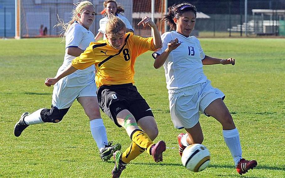 Patch's Lauren Rittenhouse, center, gets off a shot against Ramstein's Karin Mol. Rittenhouse scored Patch's first goal and the Lady Panthers went on to beat Ramstein, 2-1, in the Division I girls soccer title game.