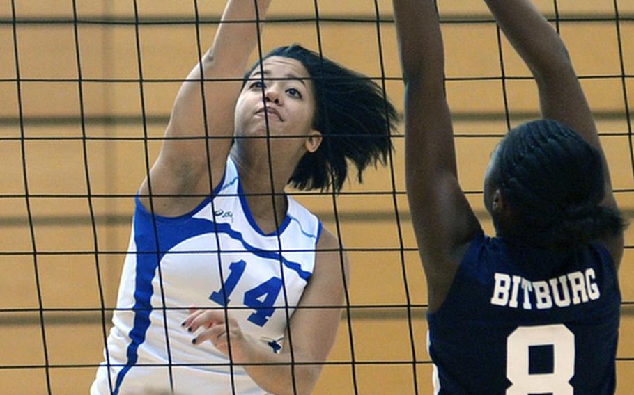 Wiesbaden's LeAmber Thomas, left, knocks the ball over Ellisia Kimble's outstretched arms in Wiesbaden's 25-16, 25-14, 25-13 win over the visiting Bitburg Lady Barons on Oct. 9, 2010.  Thomas, who recently graduated from Wiesbaden High School, has been named the 2011 DODDS-Europe female athlete of the year.