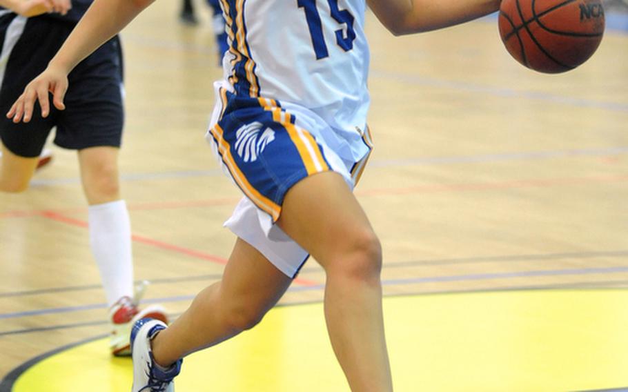 LeAmber Thomas looks to the basket as she drives the ball up the court at the DODDS-Europe basketball championships in Mannheim in February. Thomas, who recently graduated from Wiesbaden High School, has been named the 2011 DODDS-Europe female athlete of the year.