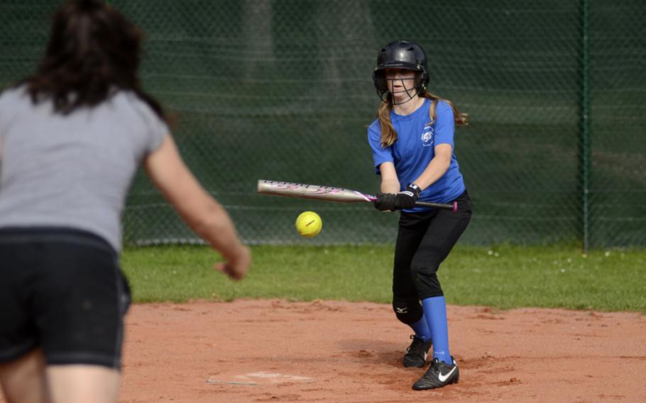 Kami Steinbacher, second baseman-out fielder for the 11-12 year-old All-Stars, lays down a bunt as manager Sheryl Goar pitches batting practice July 6, 2012. The team is preparing to represent Germany at the upcoming Little League Regionals at Caronno Pertusella, Italy.