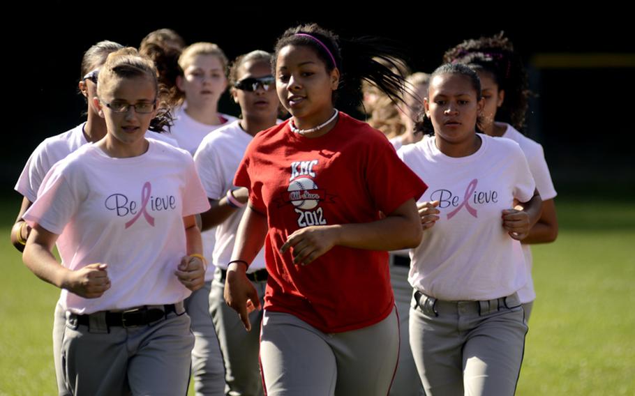 Members of the Kaiserslautern Military Community 13-14 year-old softball All-Stars, warm up before practice July 6, 2012, as they prepare to represent Germany at the European Little League Regionals at Caronno Pertusella, Italy.