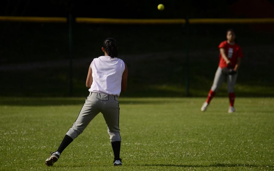 Mackenzie Brester-Knight, center fielder for the 13-14 year-old All-Stars, throws the ball to shortstop Kaitlyn Hawkins during practice July 6, 2012.