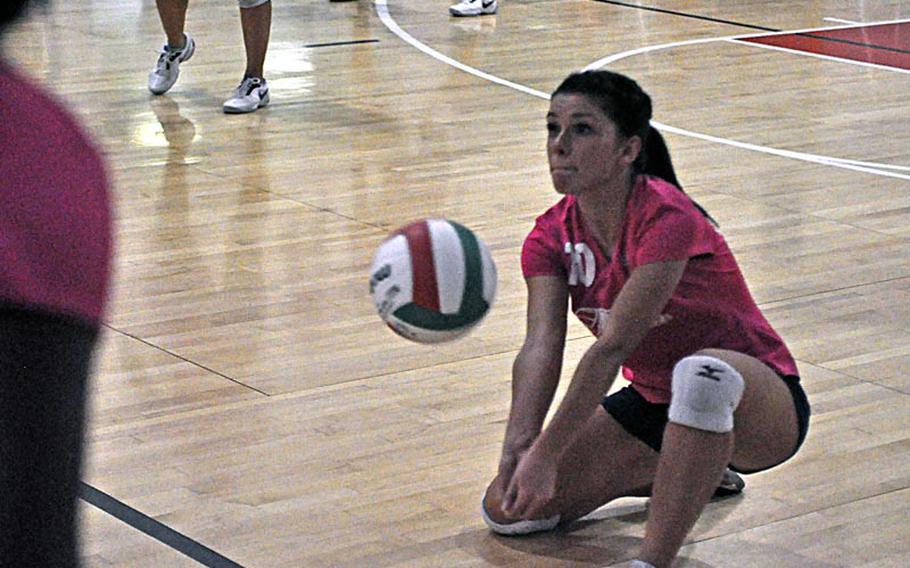 Aviano senior Giulia Silvi goes low to dig a ball in the Saints' 25-14, 33-31, 25-15 loss to the American Overseas School of Rome.