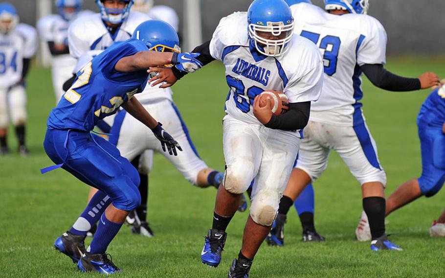 Rota's Onele Lozano manages to get away from Bamberg's Kaleb Flammang for a gain late in the Division III football game in Bamberg, Saturday. The Barons defeated the visiting Admirals 22-12.