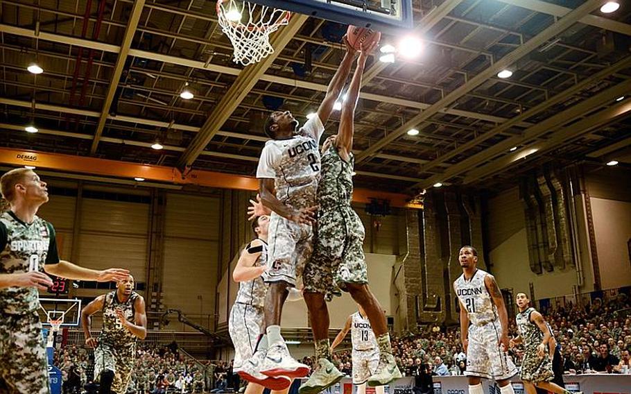 Connecticut's DeAndre Daniels blocks Michigan State's Gary Harris in the Armed Forces Classic on Nov. 9, 2012, at Ramstein Air Base, Germany. Connecticut upset No. 14 Michigan State 66-62.