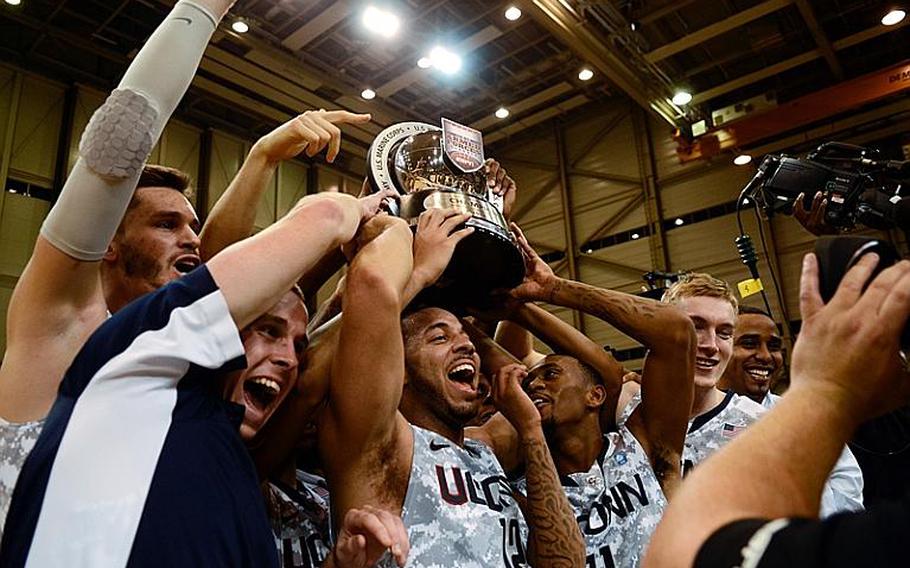 Connecticut players celebrate after they upset No. 14 Michigan State 66-62 in the Armed Forces Classic at Ramstein Air Base, Germany, on Nov. 9, 2012.