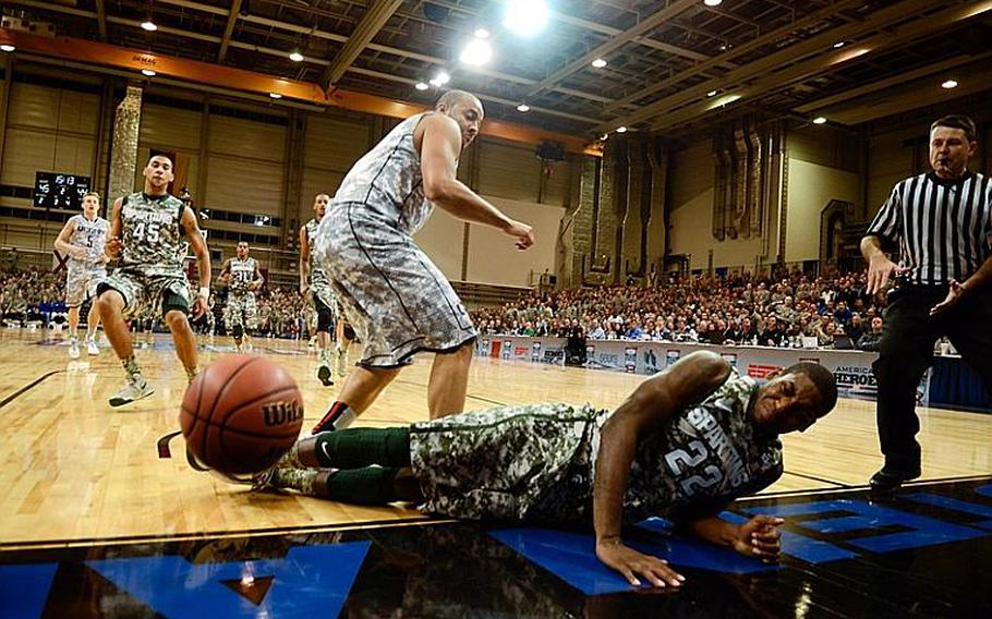 Michigan State's Branden Dawson is fouled hard by Connecticu's R.J. Evans Nov. 9, 2012, in the Armed Forces Classic at Ramstein Air Base, Germany. Connecticut upset No. 14 Michigan State 66-62.