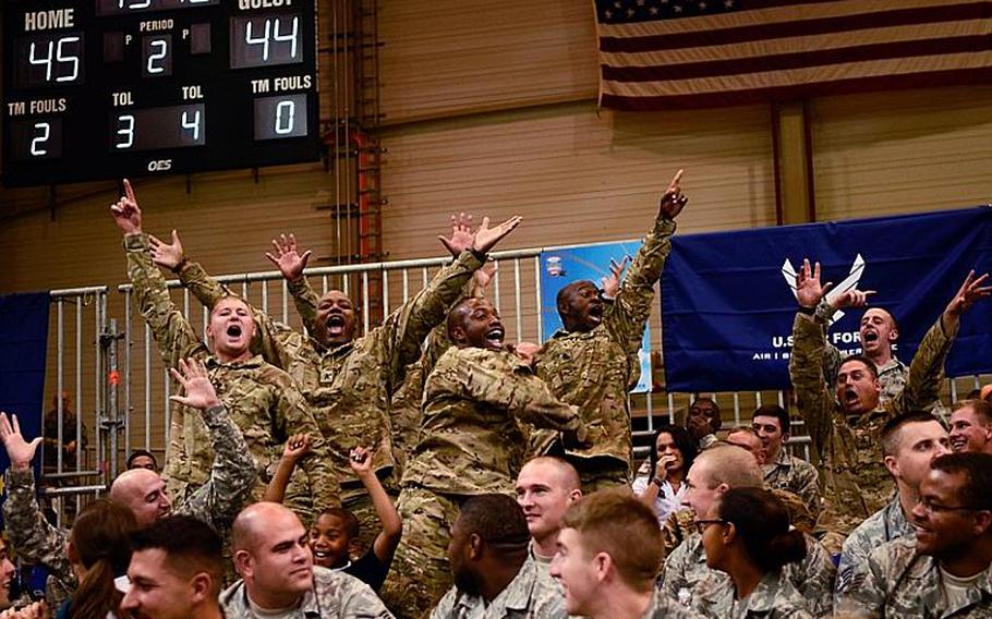 Servicemembers react to the music Nov. 9, 2012, at the Armed Forces Classic at Ramstein Air Base, Germany. Connecticut upset No. 14 Michigan State 66-62.