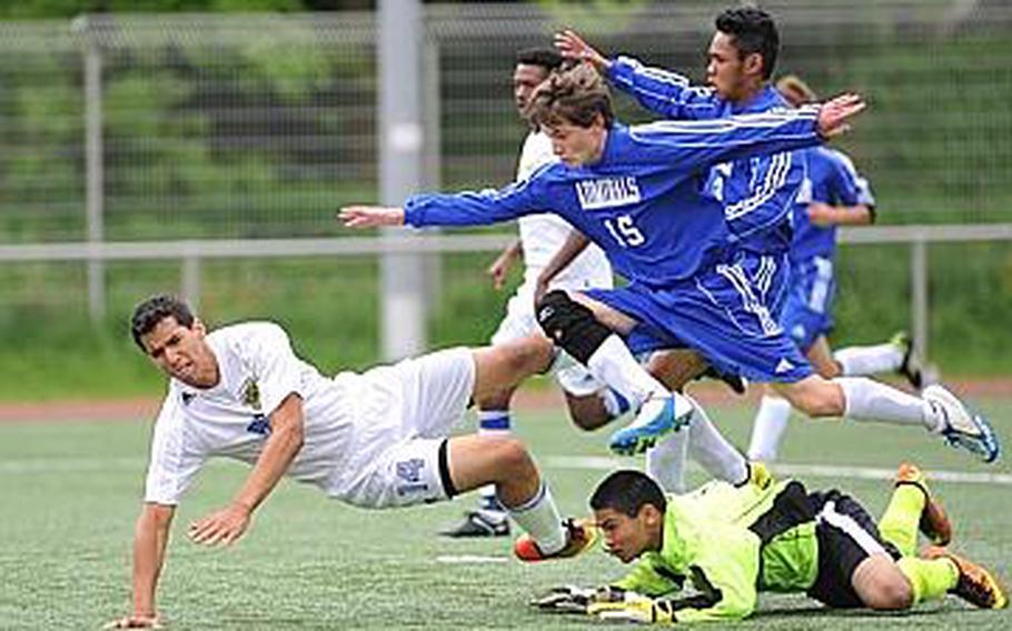 Everyone goes flying over Rota keeper Jonas Camacho including Sigonella's Antonio Garcia-Diaz and teammates John Gartland, center, and Chester Decastro. Sigonella defeated Rota 4-2 in the Division III matchup.