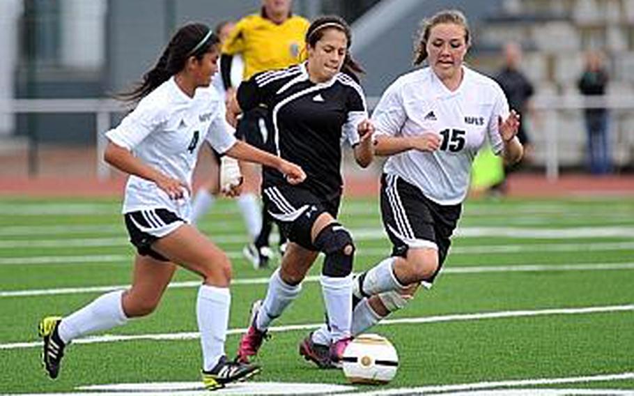 Vicenza's Alexandra Frank takes the ball upfield between Amanda Ortega, left, and Montana Bieder of Naples in the Division II final at the DODDS-Europe soccer championships in Kaiserslautern, Germany, Thursday. Defending champion Naples beat the Cougars 2-1 for the title.